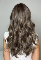 Woman with long, wavy brunette wig with highlights (Witherspoon by Belle Tress in Truffle Cream R)