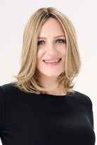 Model is wearing Barely There Straight 12" Topper by Envy in color Prosecco