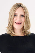 Model is wearing Barely There Straight 12" Topper by Envy in color Prosecco