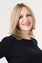 Model is wearing Barely There Straight 12" Topper by Envy in color Prosecco