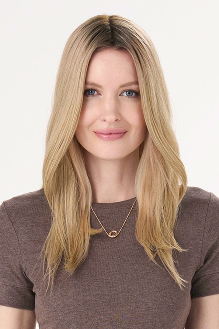 Model is wearing Barely There Straight Hair Topper by Envy 16" in color Blondie