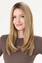 Model is wearing Barely There Straight Hair Topper by Envy 16" in color Blondie