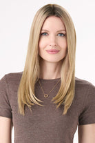 Model is wearing Barely There Straight Hair Topper by Envy 16" in color Blondie