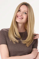 Model is wearing Barely There Straight Hair Topper by Envy 16" in color Blondie