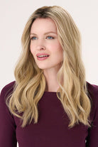 Model is wearing Barely There Wavy Hair Topper 16" by Envy in color Blondie