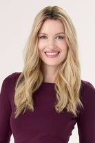 Model is wearing Barely There Wavy Hair Topper 16" by Envy in color Blondie