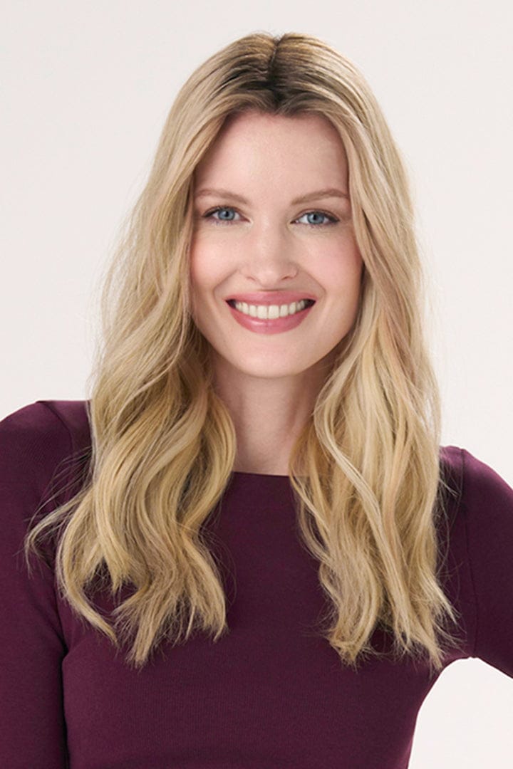 Model is wearing Barely There Wavy Hair Topper 16" by Envy in color Blondie