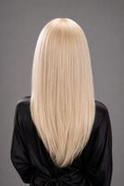 Woman wearing Bespoke Human Hair Wig by PUSH in color Carte Platine | A light, coolish-toned platinum blonde with icy, white hues for a modern, high-impact look. - Back view.