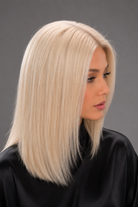Woman wearing Bespoke Human Hair Wig by PUSH in color Carte Platine | A light, coolish-toned platinum blonde with icy, white hues for a modern, high-impact look. - Side view.