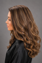 Woman wearing Remy Human Hair Wig by PUSH 14-22" - Left side view in color Belle | A base of rich brown, complemented by highlights in both light brown and medium ash blonde, creating a multi-dimensional and natural-looking effect.