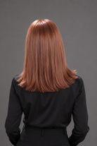 Woman wearing Bespoke Human Hair Wig by PUSH 14" in color Light Ginger Brown Mix with a black blouse on. Back view.