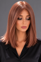 Woman wearing Bespoke Human Hair Wig by PUSH 14" in color Light Ginger Brown Mix with a black blouse on. Front view.