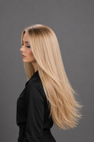 Woman wearing Bespoke Human Hair Wig by PUSH 20-26" in color Soleil with black blouse and black pants. Left side view.