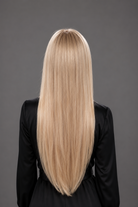 Woman wearing Bespoke 24-30" Human Hair Wig by PUSH in color Glacial with black top and pants. Back view.