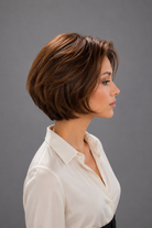 Woman wearing Bespoke Human Hair Wig by PUSH in color Noisette with a button down cream blouse. Right side view.