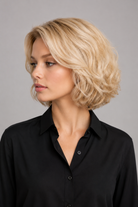 Woman wearing Bespoke Human Hair Wig 5-13" in color Blond Platine Racine Miel with black button down blouse. Left side view.