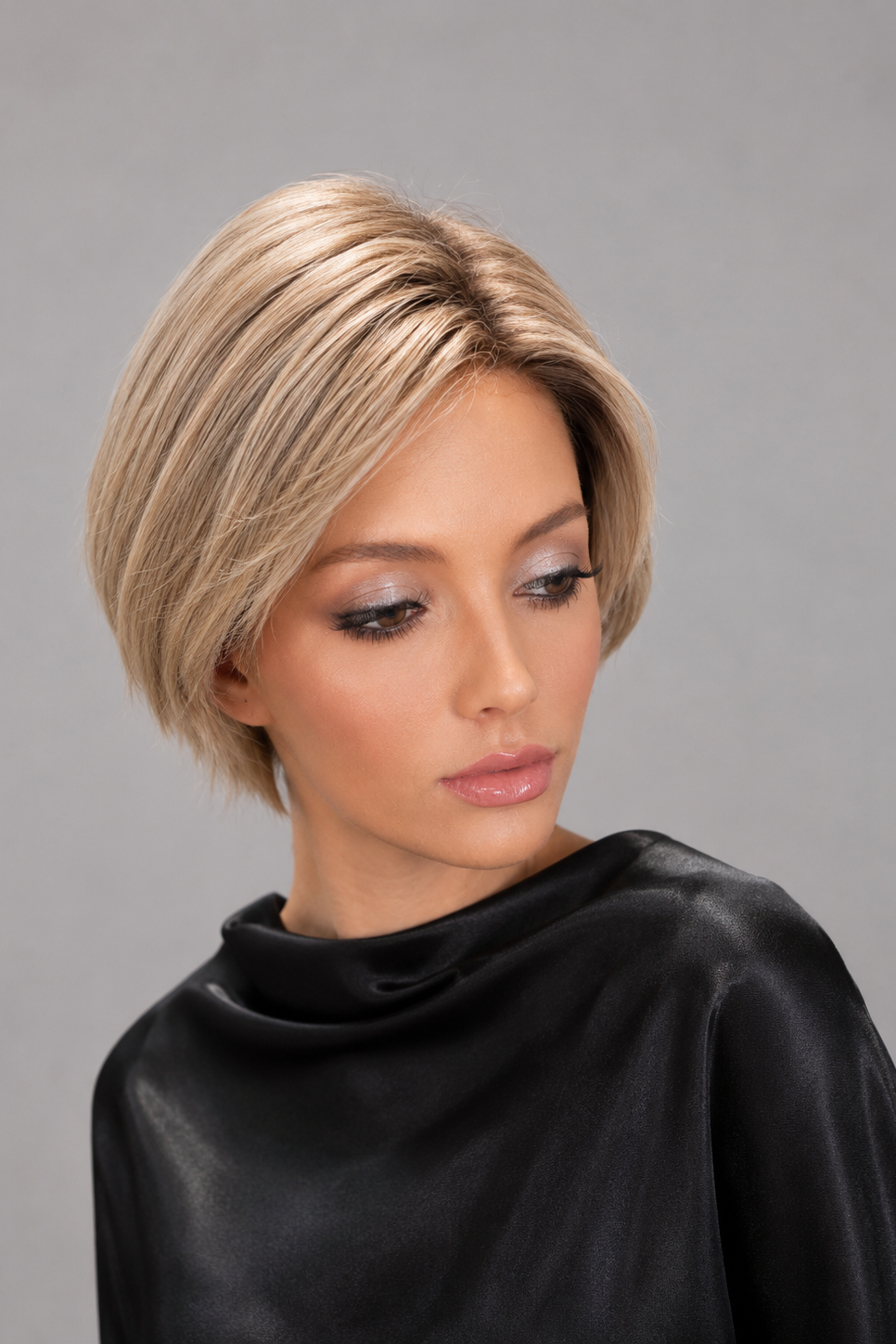 Woman wearing short human hair wig by PUSH in color Champagne Rooted | Front view.
