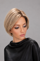 Woman wearing short human hair wig by PUSH in color Champagne Rooted | Front view.