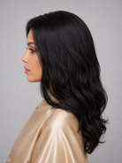 Woman wearing 24" long wavy human hair wig by PUSH Hair in color Noir - Left side view.