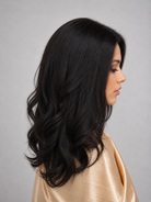 Woman wearing 24" long wavy human hair wig by PUSH Hair in color Noir - Right side view.