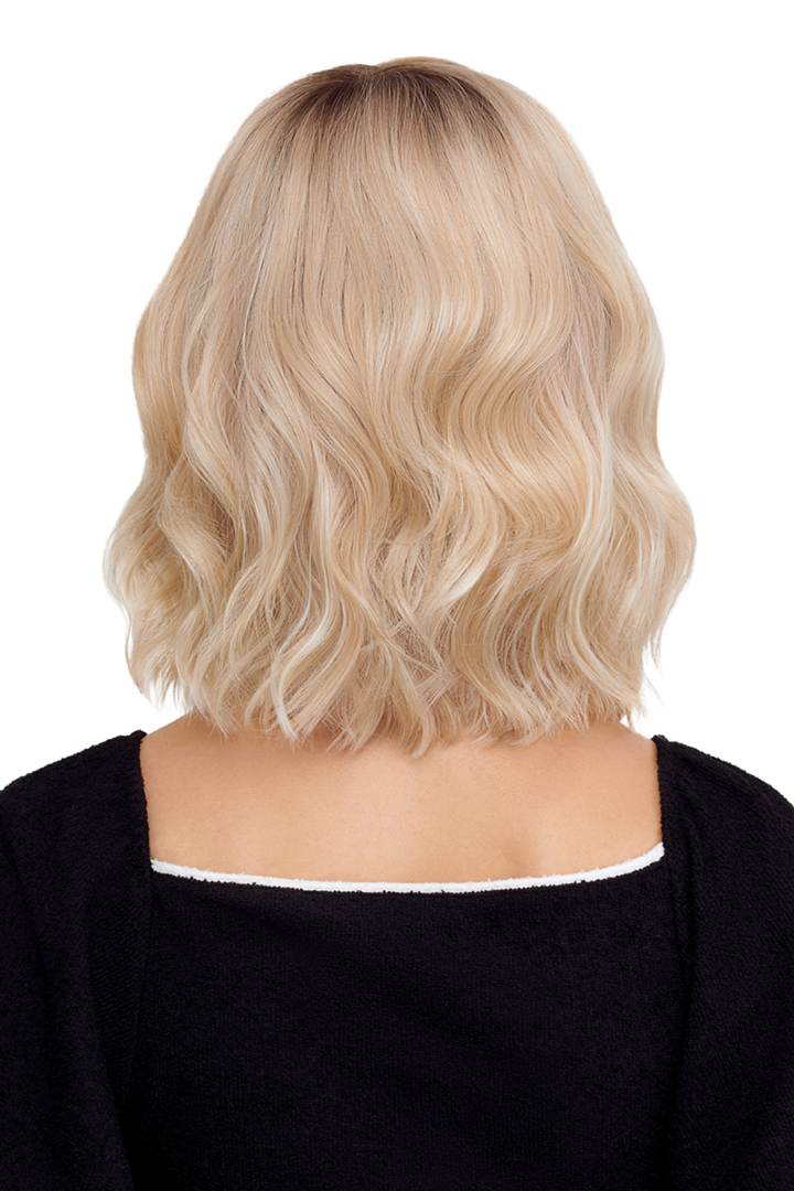 Back view of a shoulder-length, wavy blonde synthetic wig with dark roots by TressAllure.
