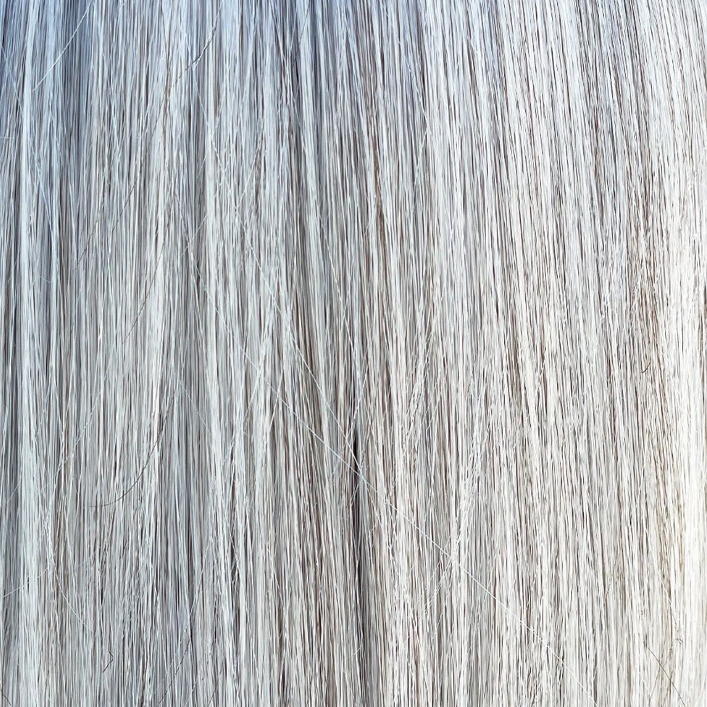 Close-up of Oxford wig in Milkshake Blonde R, showing straight, fine synthetic hair strands.