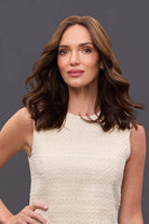 Woman wearing a 14-inch brown Remy human hair topper with a natural part and soft, wavy layers for lightweight coverage.