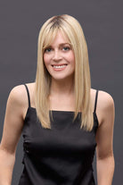 Woman wearing a 14-inch blonde Remy human hair topper with a petite base and natural-looking bangs.