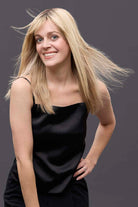 Woman wearing a 14-inch blonde Remy human hair topper with a natural, lightweight monofilament base.