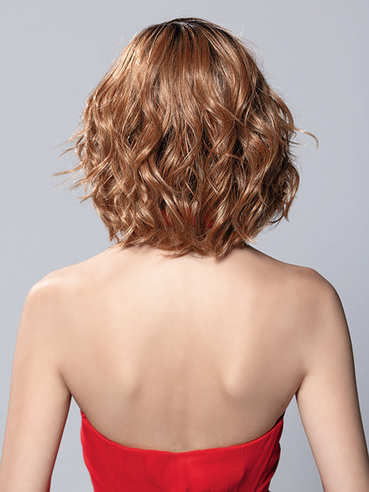 Back view of Elle Mono wavy mid-length bob wig in a warm brown shade with tousled layers and volume.