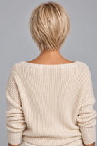 Woman wearing Emma Human Hair Wig by PUSH in color Light Champagne Crème Rooted with a cream v-neck sweater against a light grey background-back view