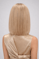 Woman wearing Genevieve human hair wig by push in color Fleur Blonde - Back view.