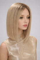 Woman wearing Genevieve human hair wig by push in color Fleur Blonde - Front view.