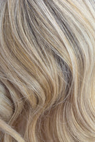 Golden Champagne Rooted | A medium neutral root melts into luminous champagne blonde ribbons with creamy vanilla highlights and soft golden beige dimension, creating a bright, natural-looking blonde with effortless depth and shine