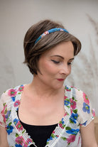 Woman with ear-length bob wig with a headband (Ivy by Jon Renau in 8RH14)