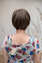 Woman with ear-length bob wig (Ivy by Jon Renau in 8RH14) back