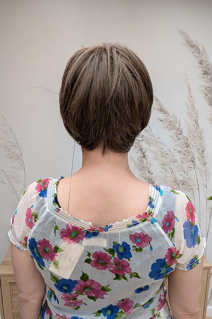 Woman with ear-length bob wig (Ivy by Jon Renau in 8RH14) back