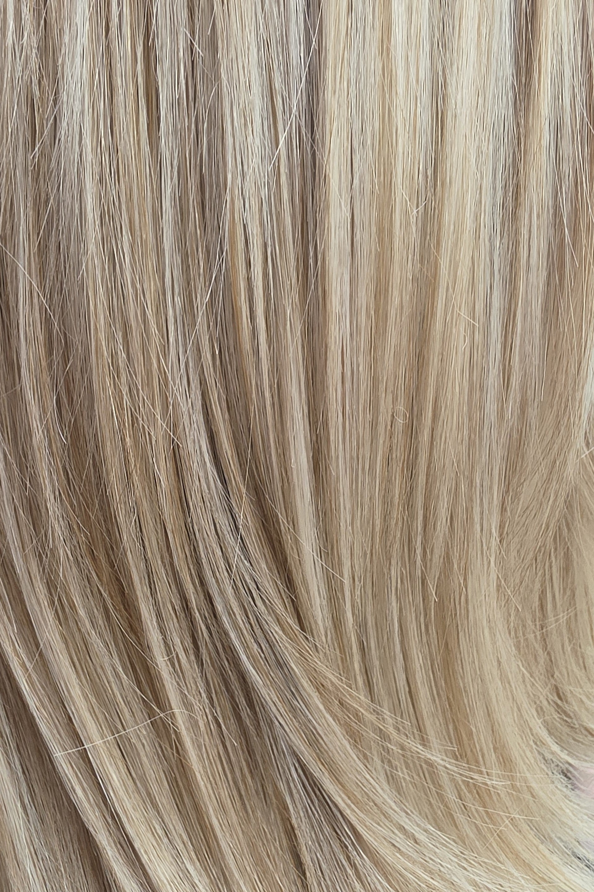 Pearl Silk Rooted | A luminous cool light blonde featuring a light beige base with creamy vanilla, champagne, and soft ivory highlights, delicately blended with light ash lowlights