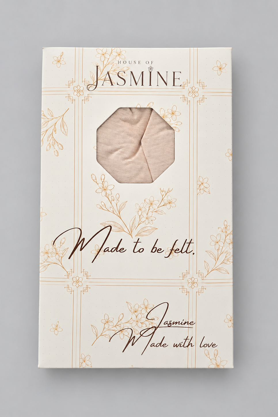 The Softness amber melange bamboo head covering packaging against a plain light gray studio background. 