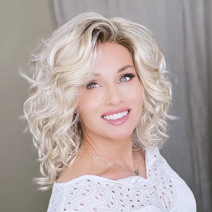 Woman wearing a curly blonde synthetic wig