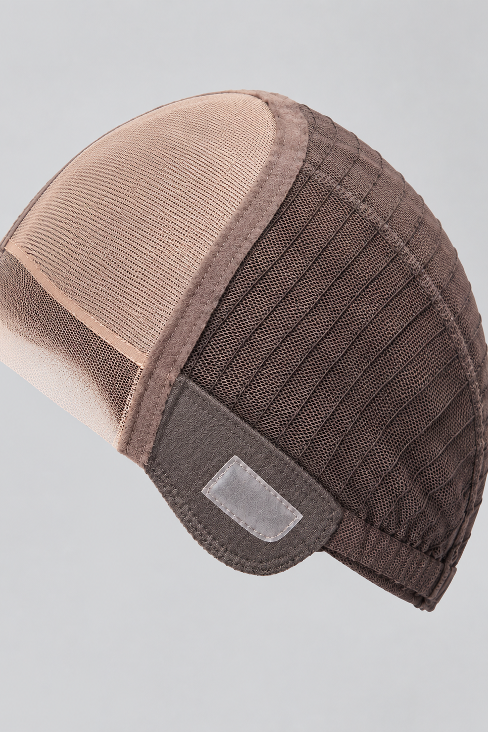 Image of a wig cap with a lace front hairline, full monofilament top and closed soft wefting in back on a white background.